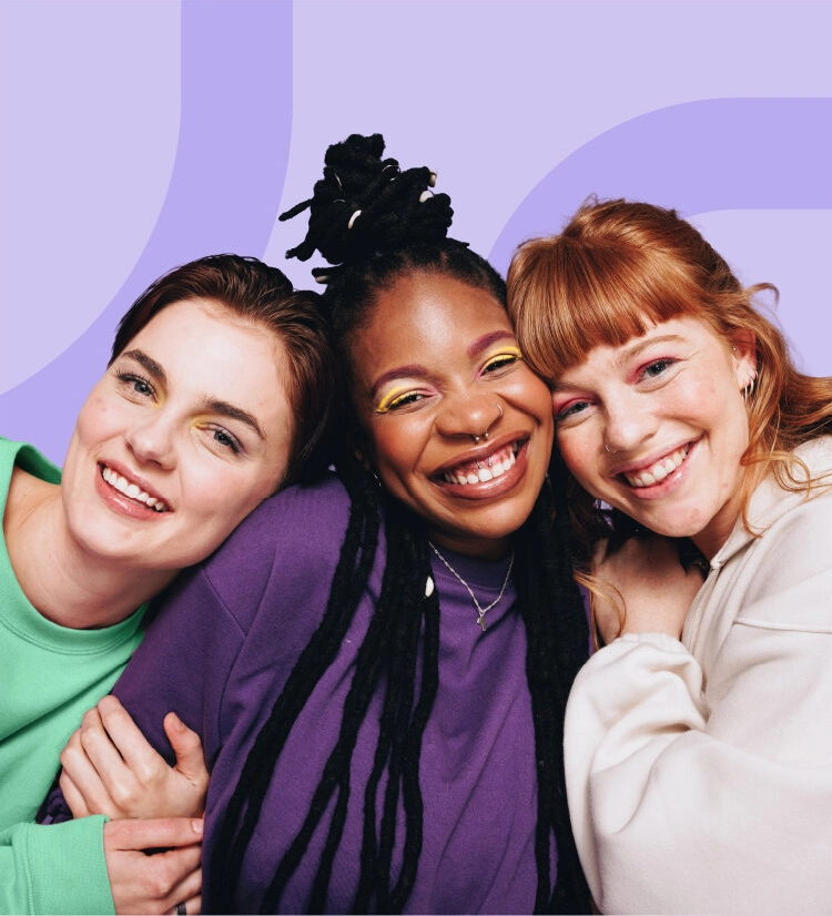 Three teenage girls with acne smiling to camera