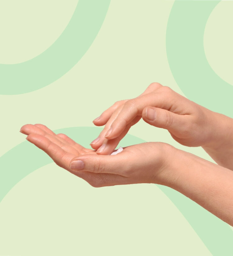 A hand holds a small amount of TWYNEO cream while the other hand dabs it to apply to the face